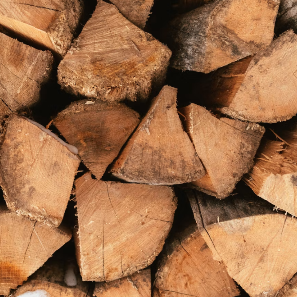 rustic stack of wood logs, showcasing the raw, earthy textures and deep, grounding tones of nature.