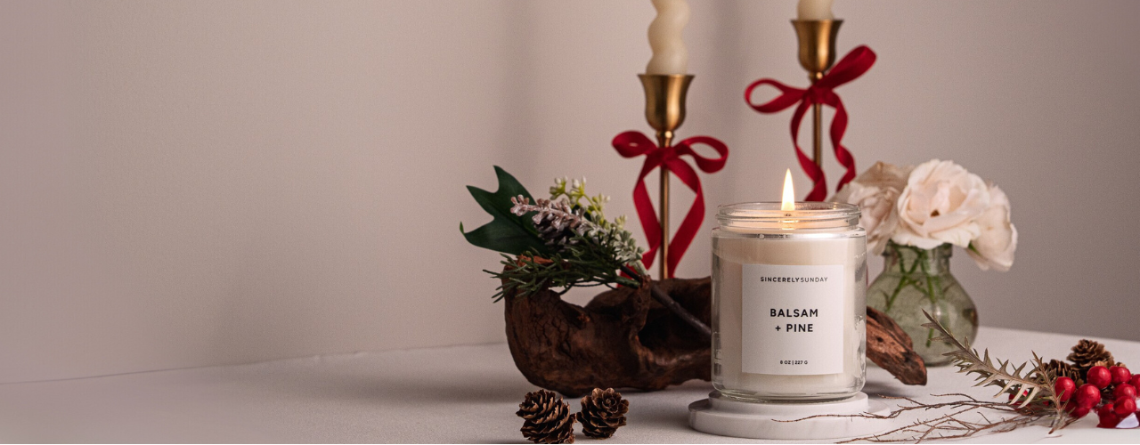 Candle with decorative elements on a neutral background