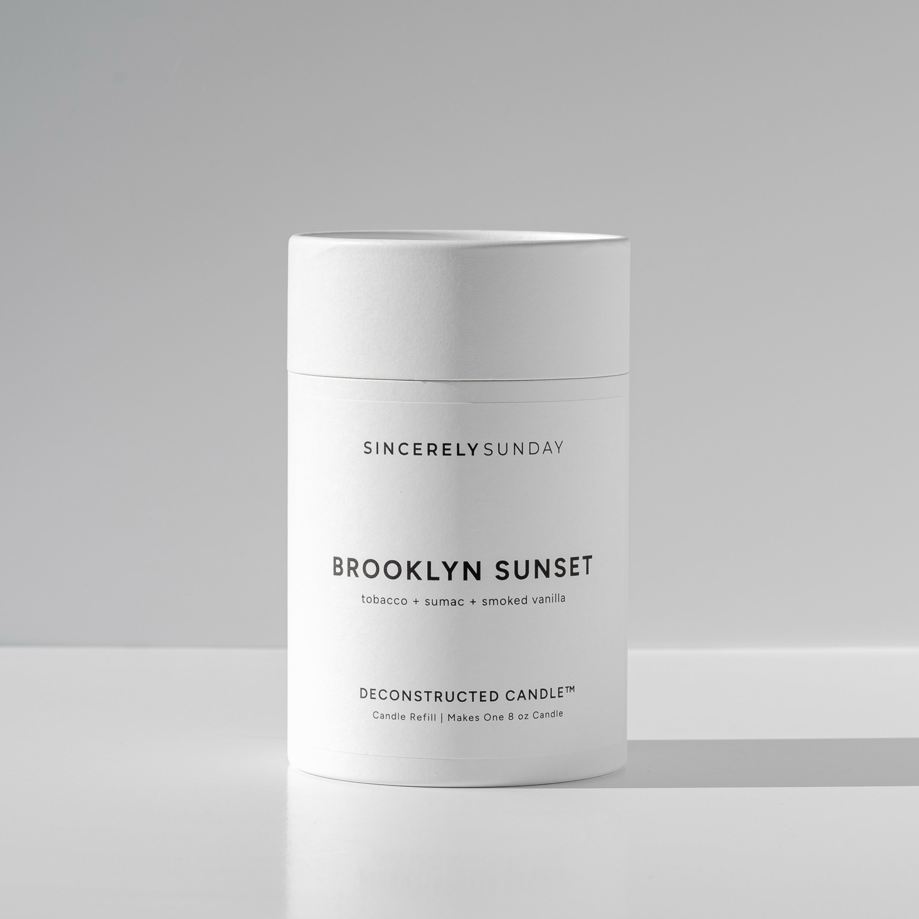 White cylindrical paper tube labeled 'Brooklyn Sunset' by Sincerely Sunday on a white background