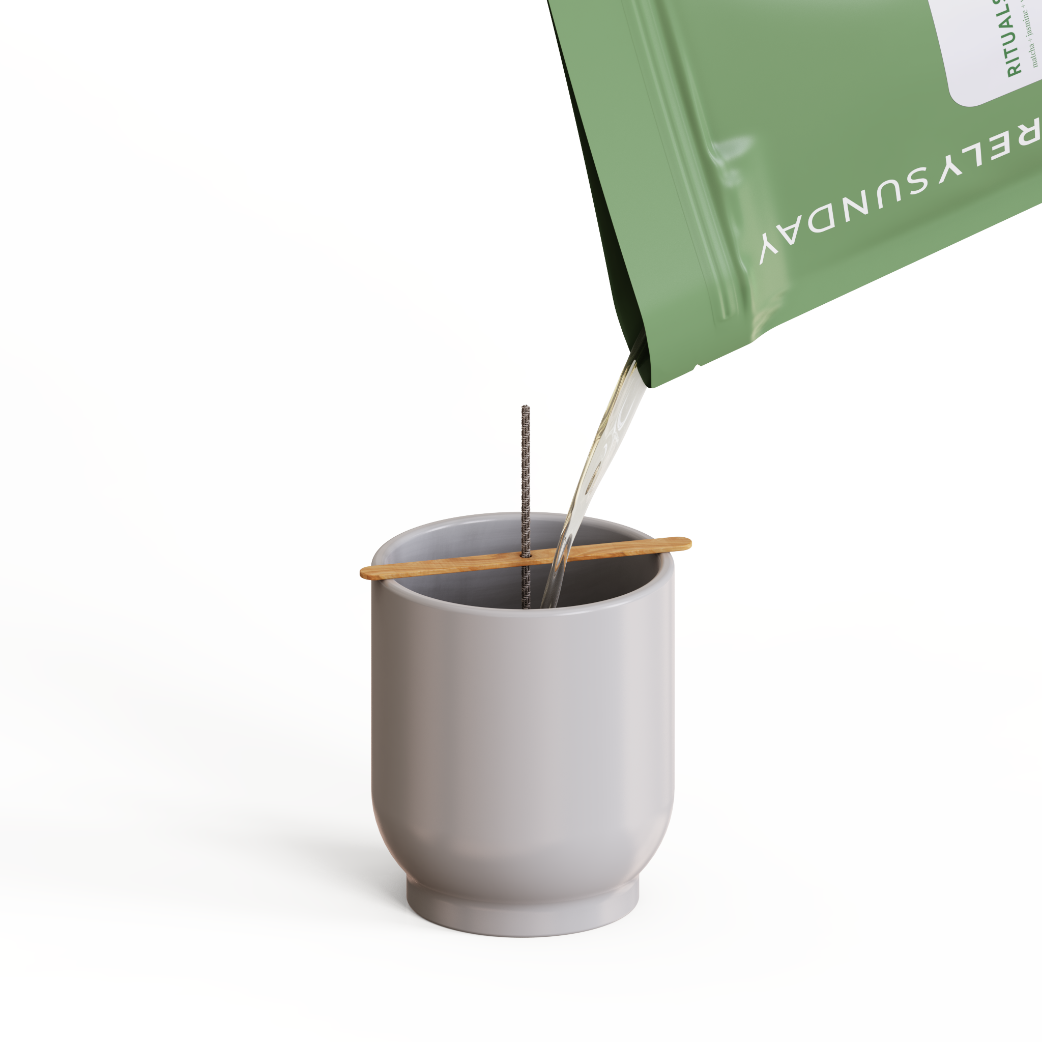 Pouring melted wax from a Deconstructed Candle™ pouch into a clear glass vessel, showing how to use the DIY kit