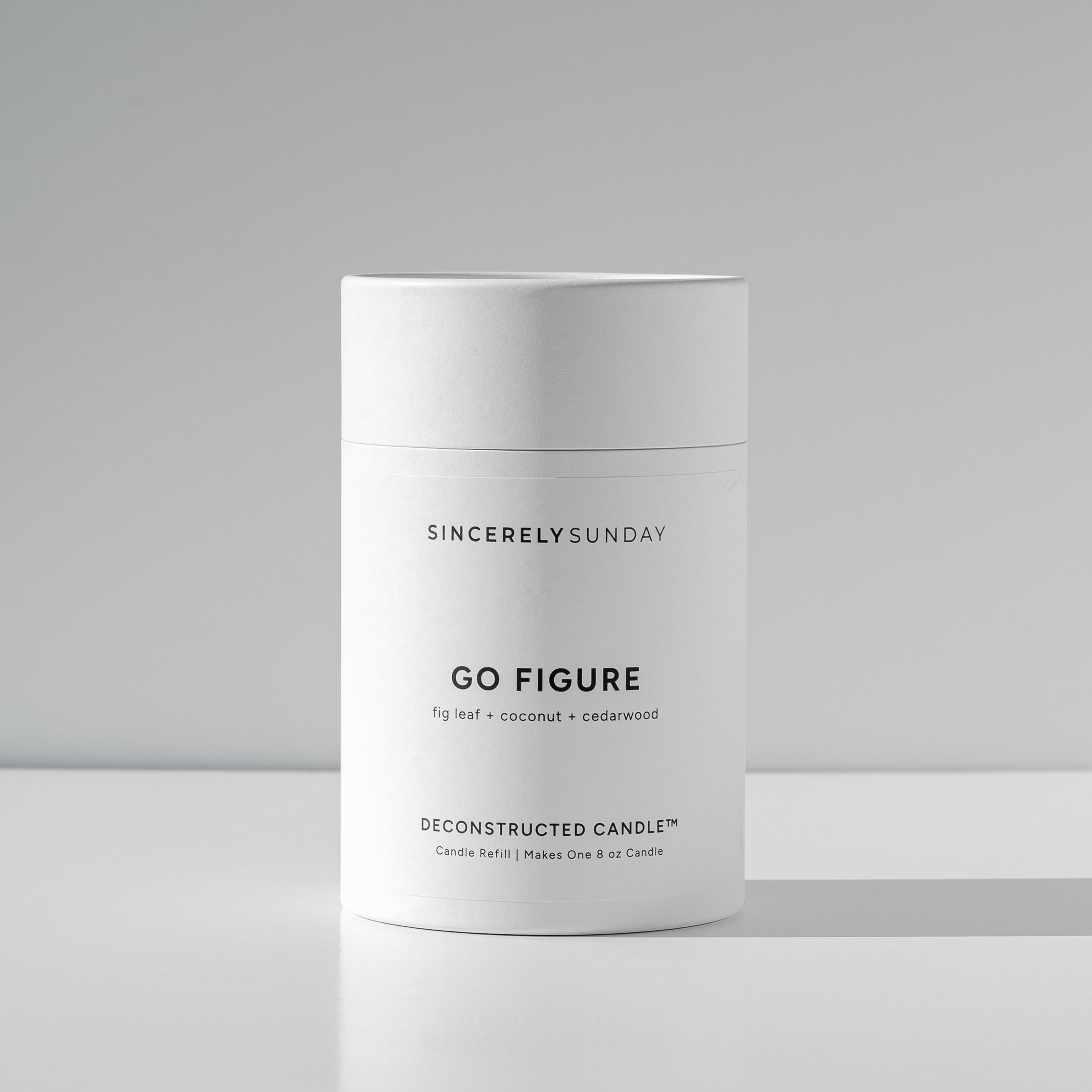 White cylindrical paper tube labeled 'Go Figure' by Sincerely Sunday on a white background