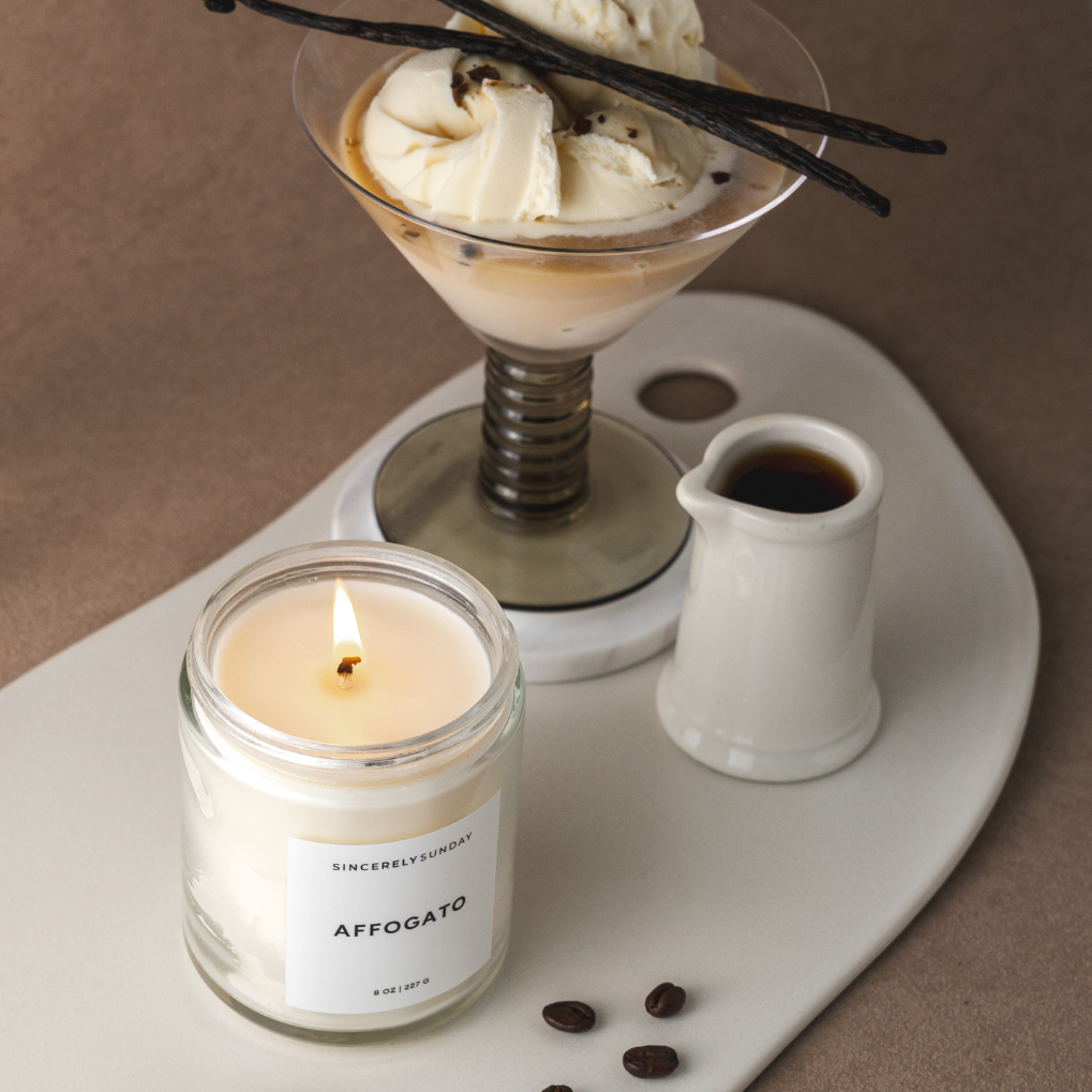 Candle labeled 'AFFOGATO' with a dessert and coffee beans on a tray