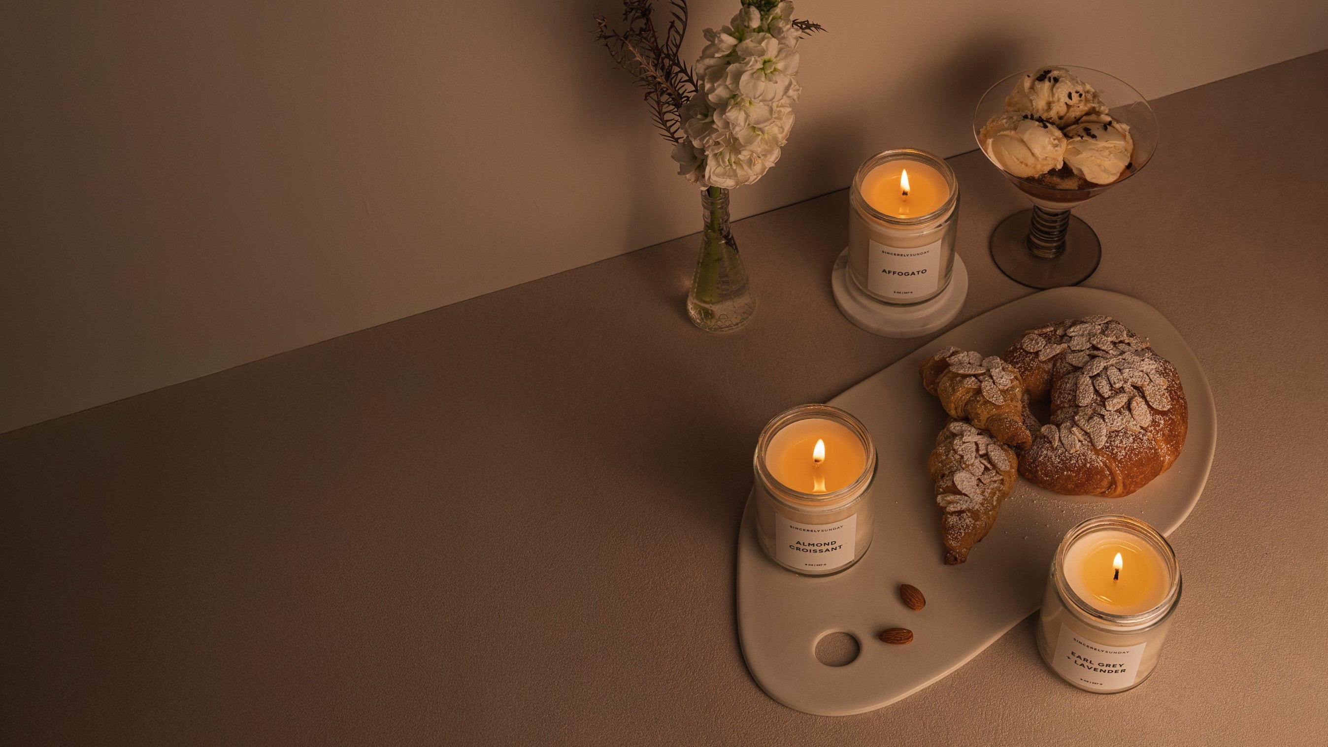 Candles and pastries on a table with a warm ambiance
