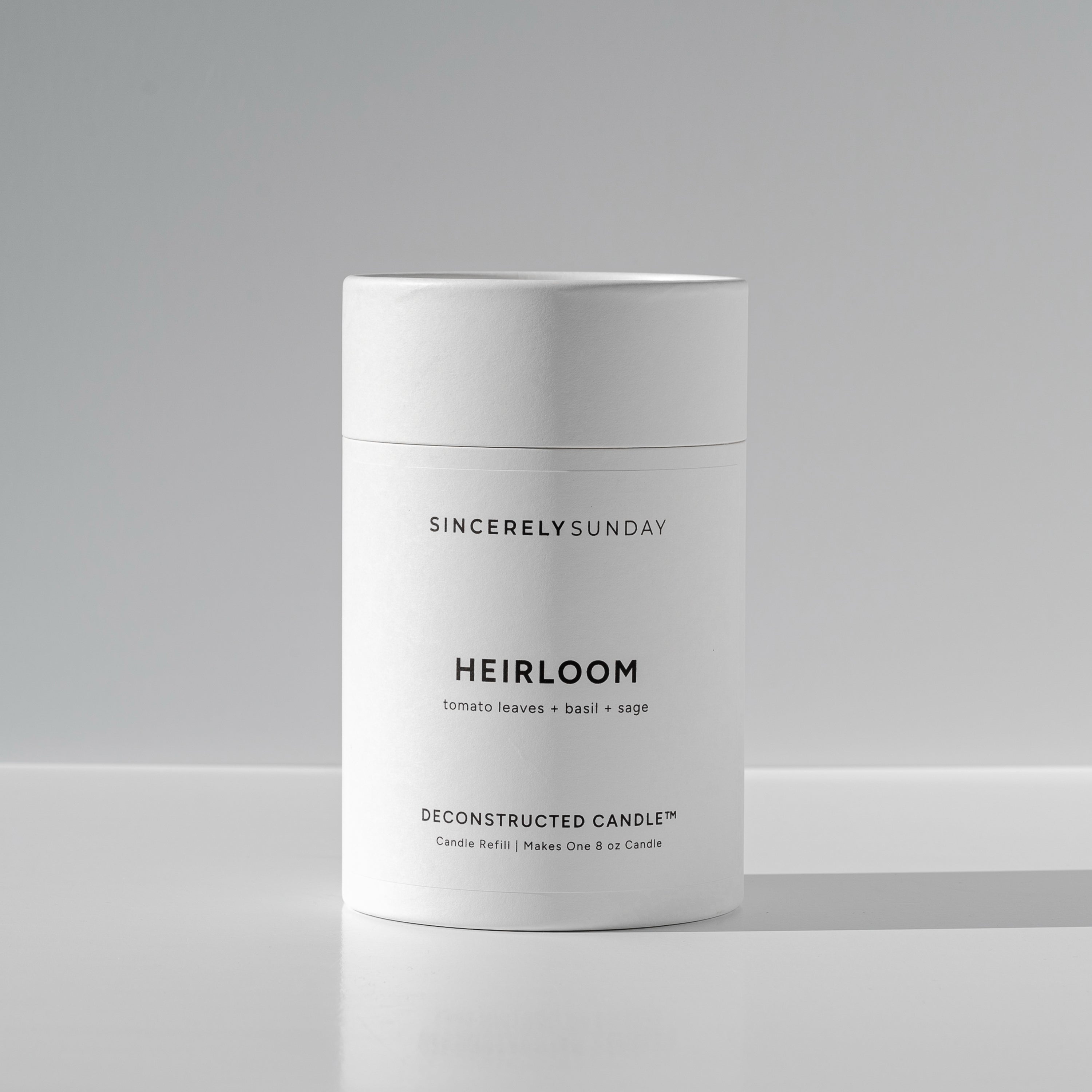 White cylindrical paper tube labeled 'Heirloom' by Sincerely Sunday on a white background
