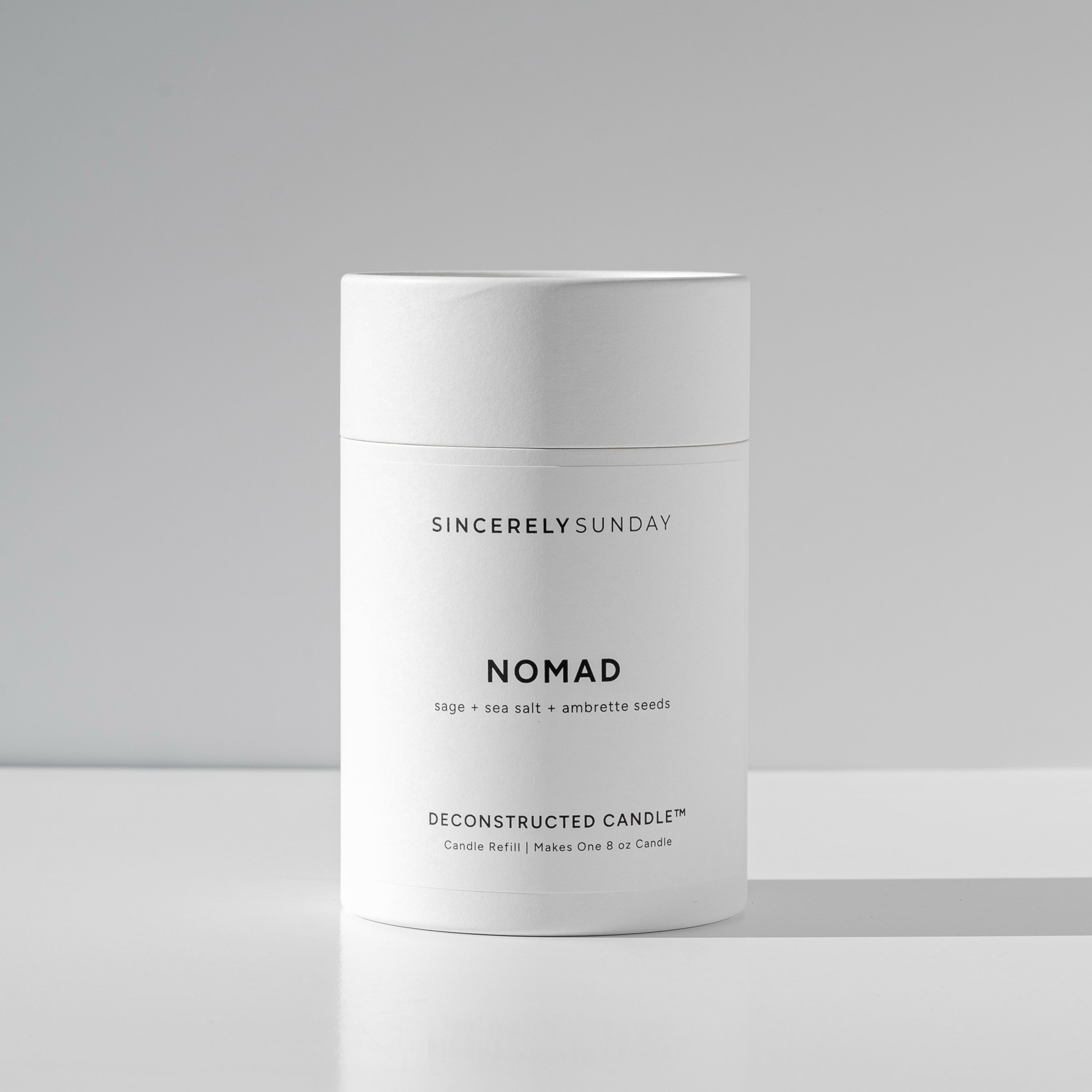 White cylindrical paper tube labeled 'Nomad' by Sincerely Sunday on a white background