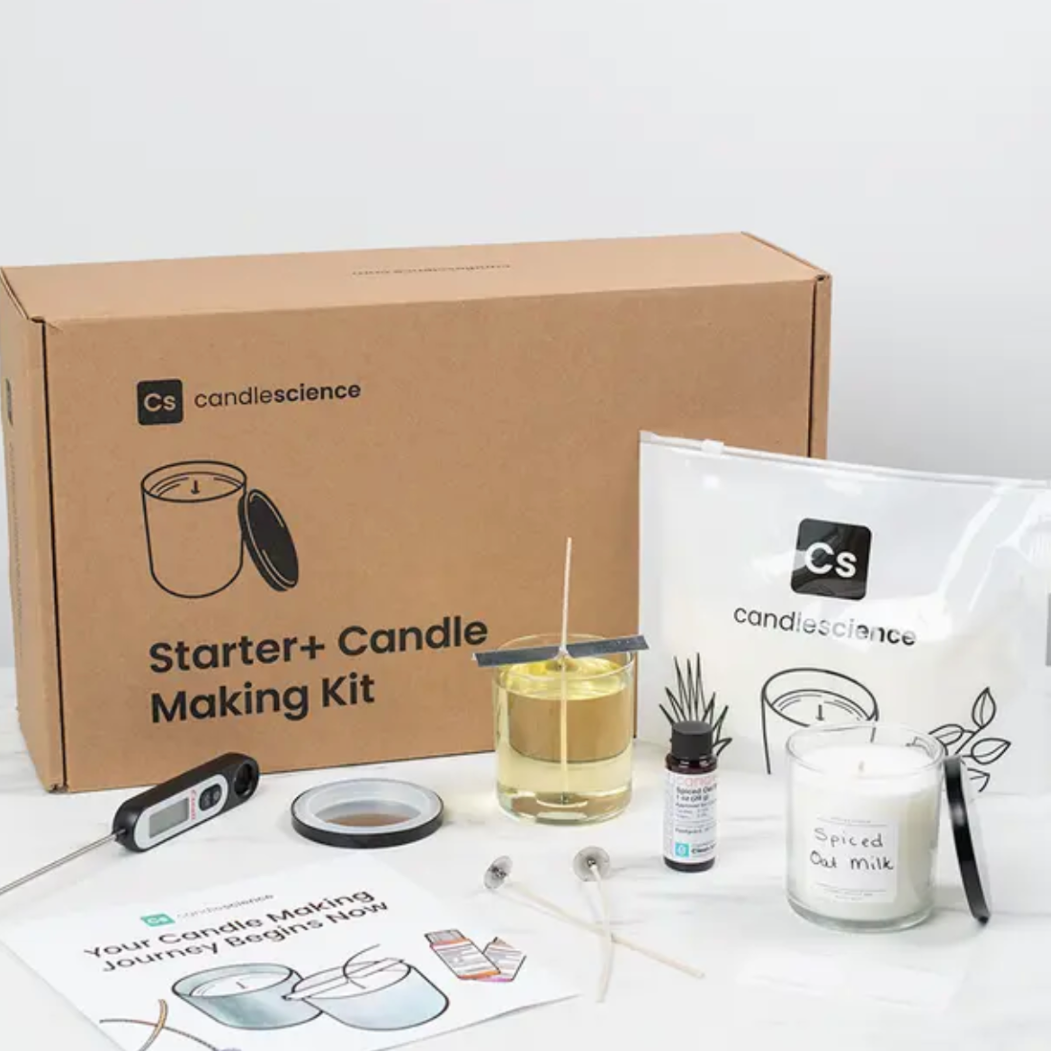 Candle making kit with materials included and a candle on a white background